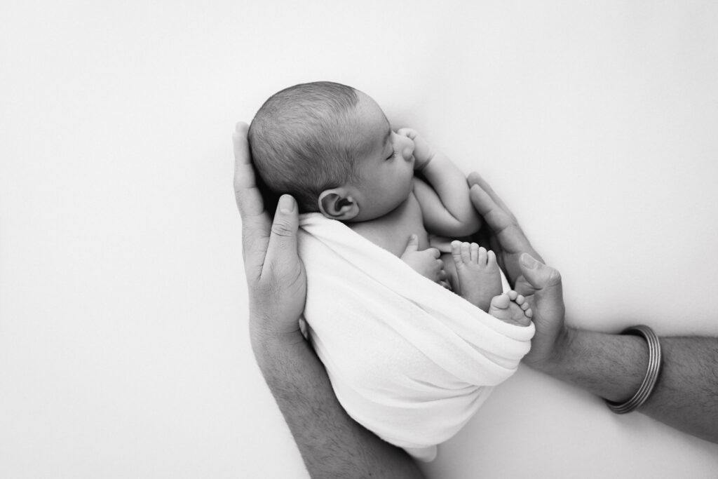 newborn boy in fathers hands indian sacramento sweet jean photography (013)