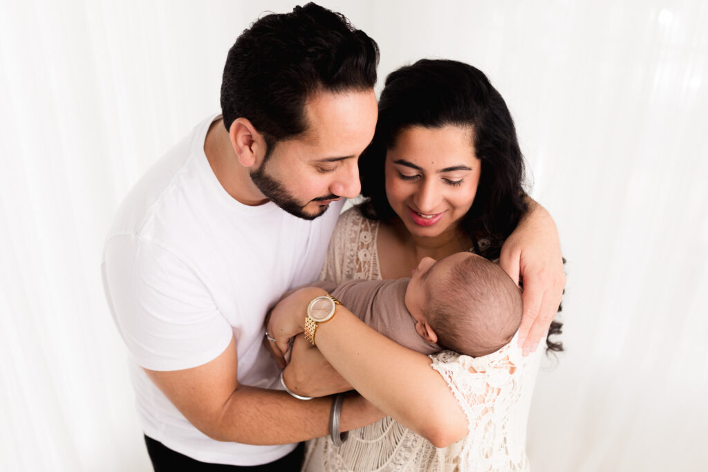 newborn boy with parents smiling indian sacramento sweet jean photography (020)