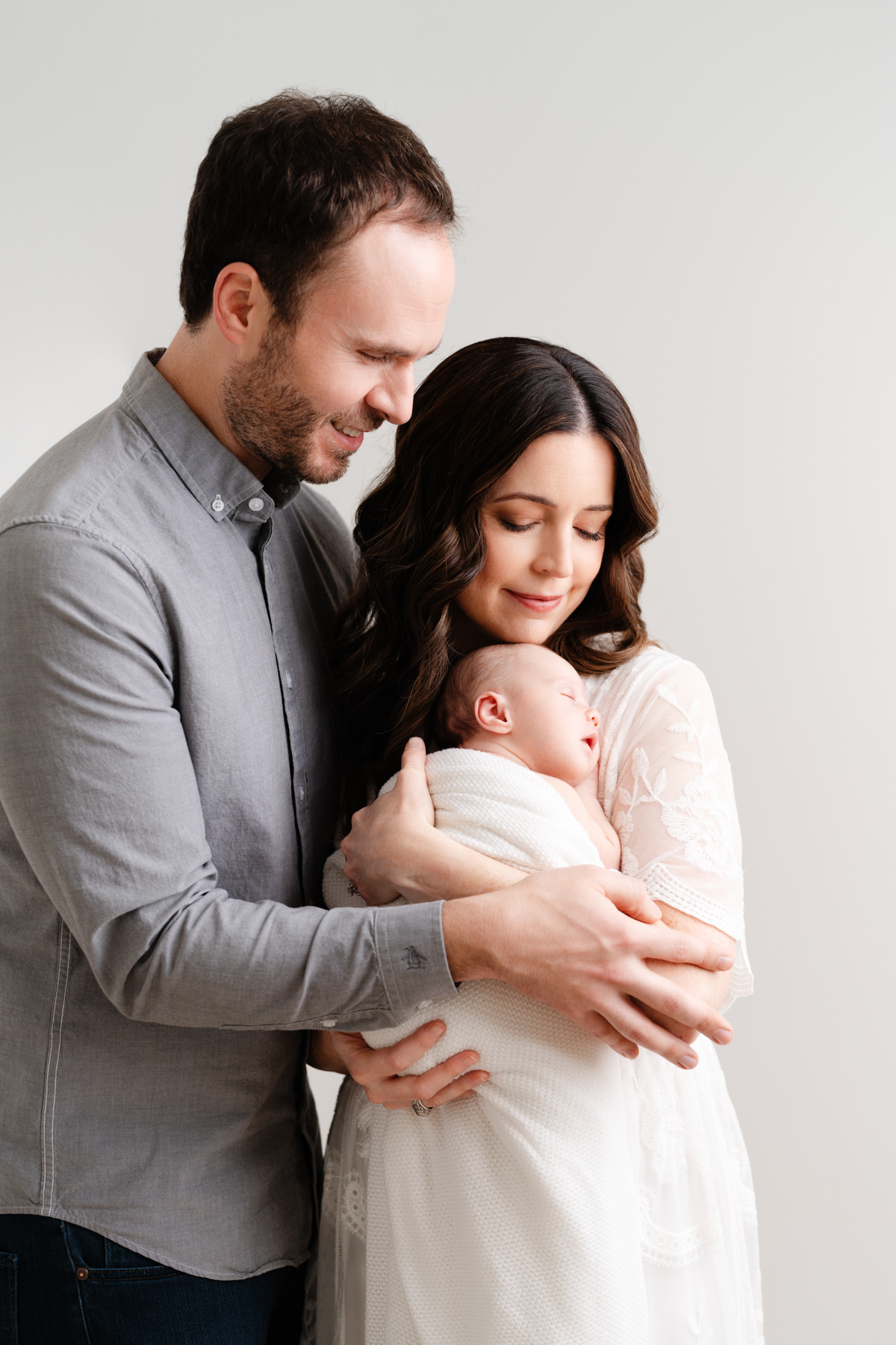 Newborn photography Sacramento CA parents holding newborn baby girl