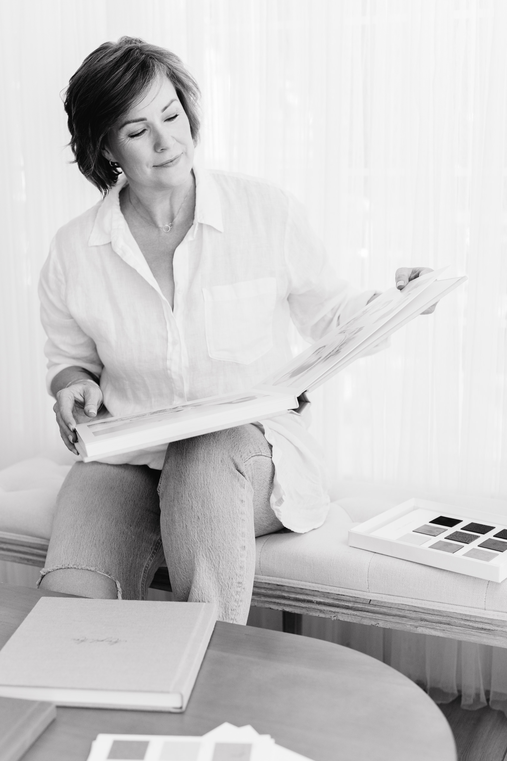 Jeanie Lapenna of Sweet Jean Photography looking through an Heirloom Album