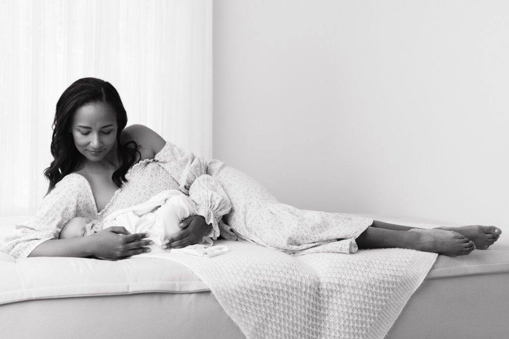 Studio newborn photographer Roseville portrait of a woman lounging with her new baby