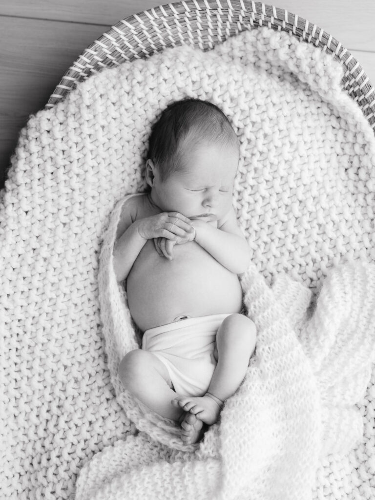 Sweet baby boy wide awake during natural newborn portrait session