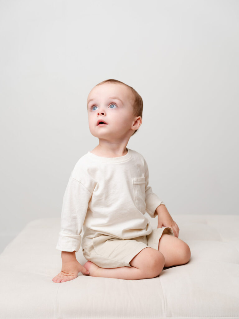 Portrait of big brother wide eyed during newborn session at Sweet Jean Photography in Roseville