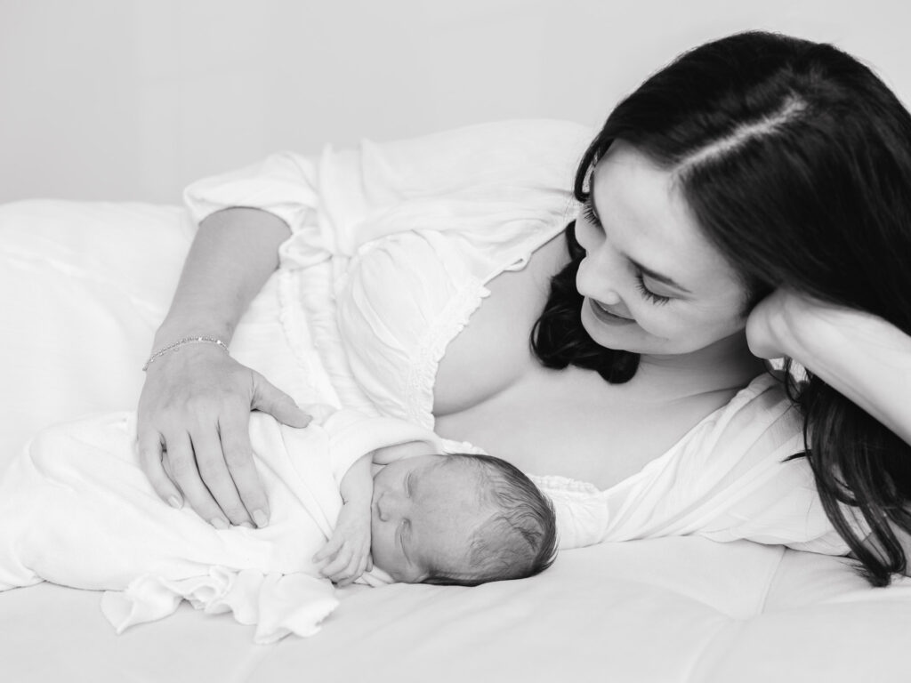 Mama cuddled close during calm newborn session in Roseville