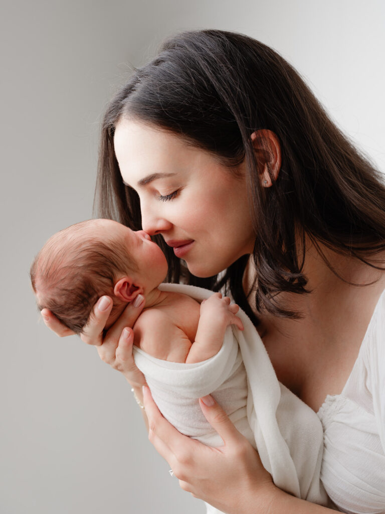 Intimate moment between mother and newborn baby boy