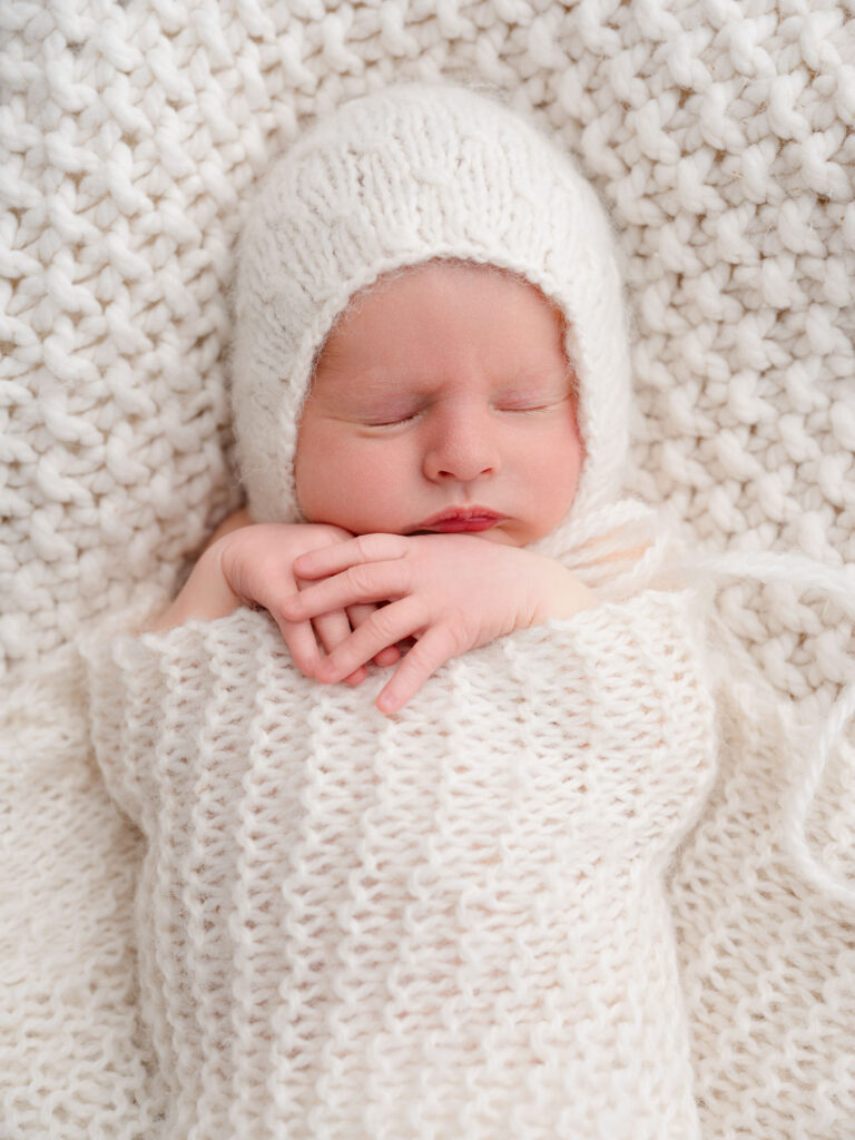 Minimalist newborn image with neutral wardrobe and natural light