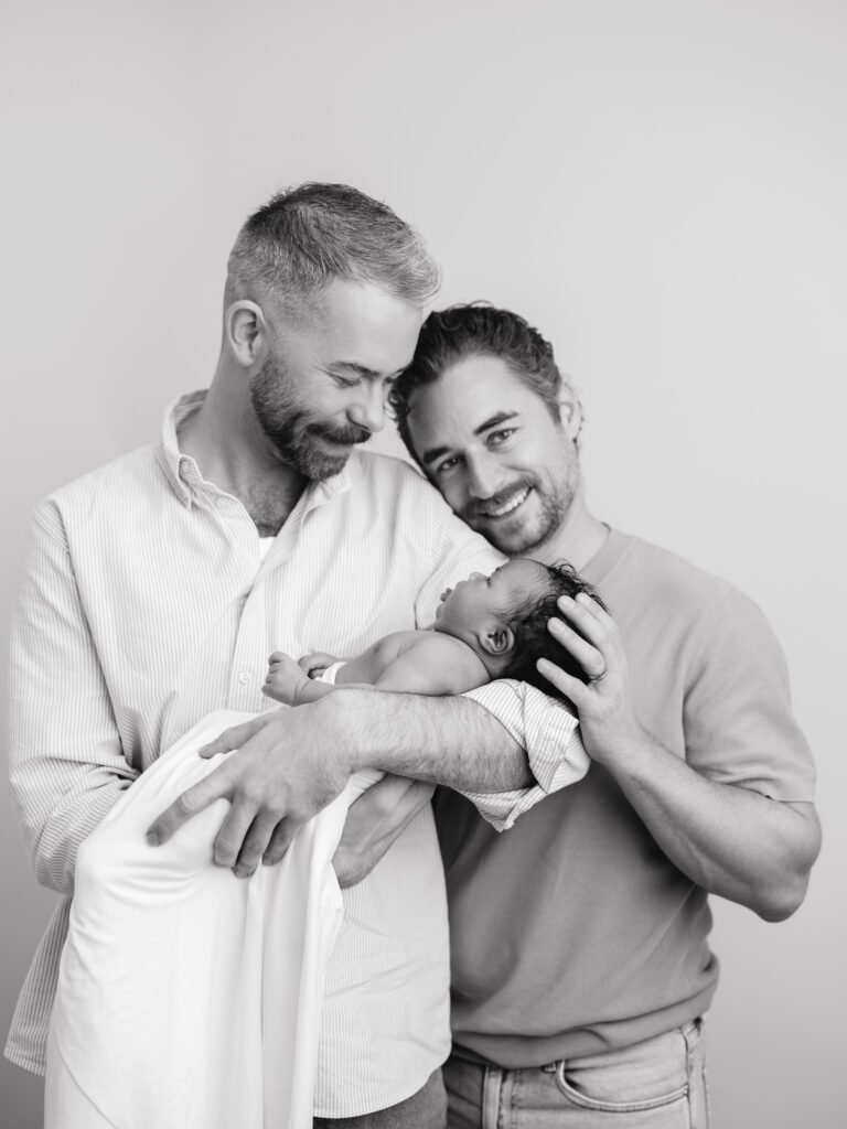 LGBTQ family surrogacy newborn photography session in a Sacramento studio
