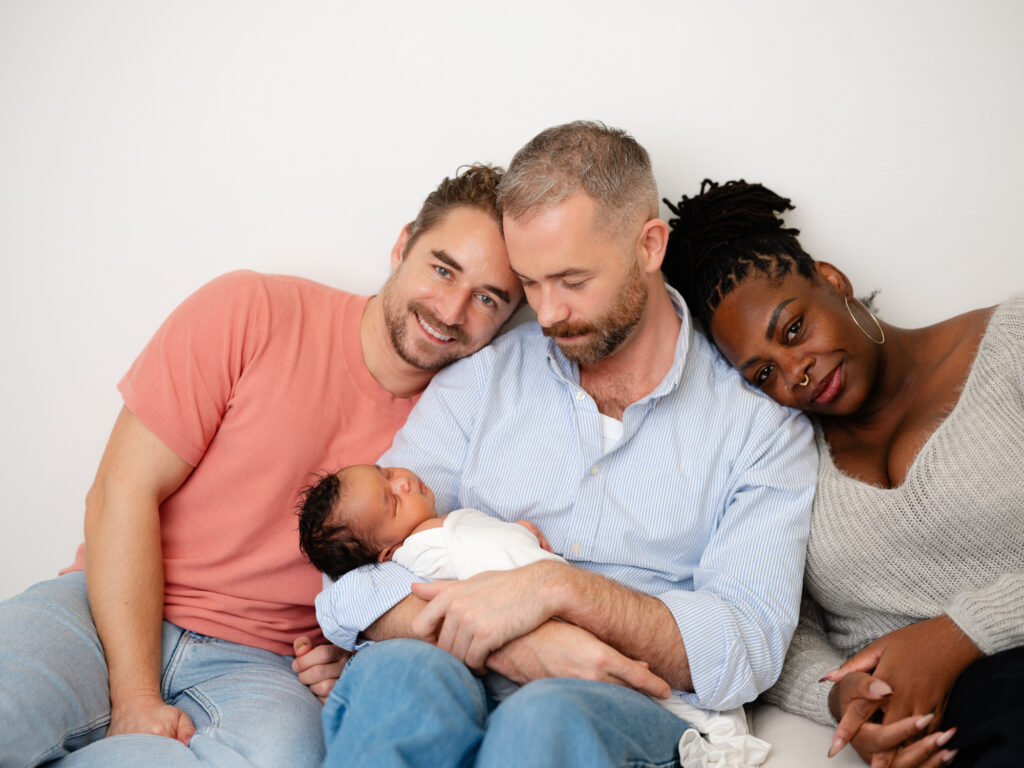 Inclusive newborn photography session documenting a surrogacy journey in Sacramento