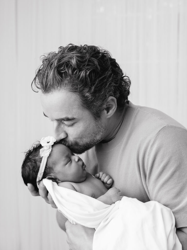 Father holding his newborn baby during an Sacramento newborn photography session