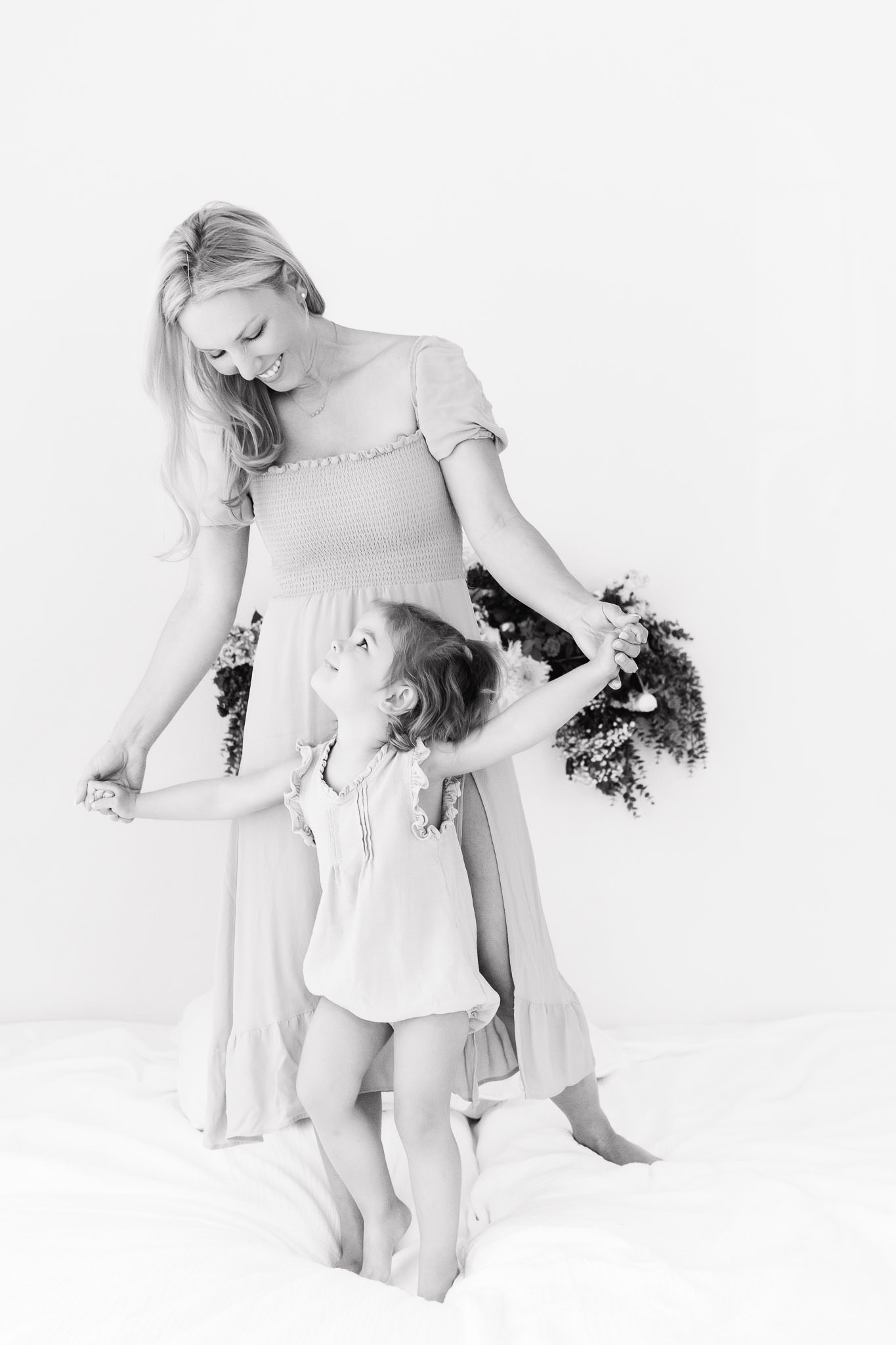 motherhood portrati of a sweet mama dancing with her little girl in black and white