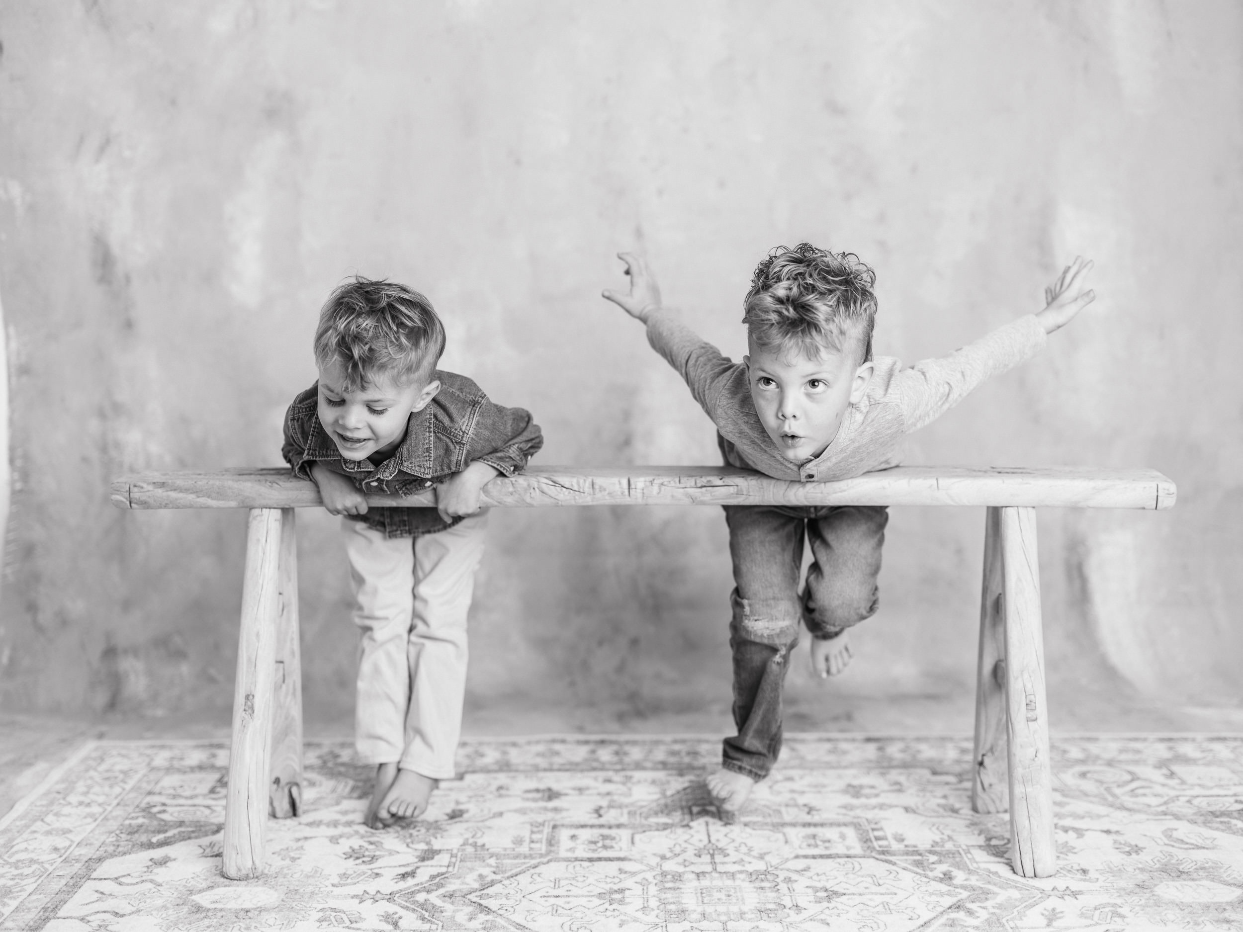 Fine art black and white childhood portrait of siblings photographed for The Light Between series in a Sacramento studio